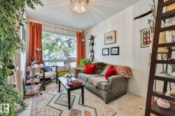 Bright living room bathed in natural light through expansive windows with orange drapery - 