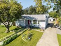 Exterior featuring a gray stucco finish, a red entry door, a prominent front window, and a concrete driveway - 8932 187 Street Nw, Edmonton, AB  - Outdoor 