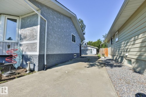 Concrete driveway with a detached garage in the background - 8932 187 Street Nw, Edmonton, AB - Outdoor With Exterior