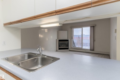 #306 4220 139 Av Nw, Edmonton, AB - Indoor Photo Showing Kitchen With Fireplace With Double Sink