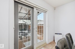 Glass-paneled sliding door opening to an outdoor deck - 