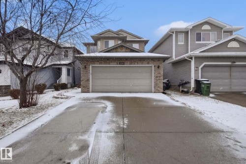 Front exterior featuring brick veneer accents, an attached garage, and a concrete driveway - 3016 24 Ave Nw, Edmonton, AB - Outdoor With Facade