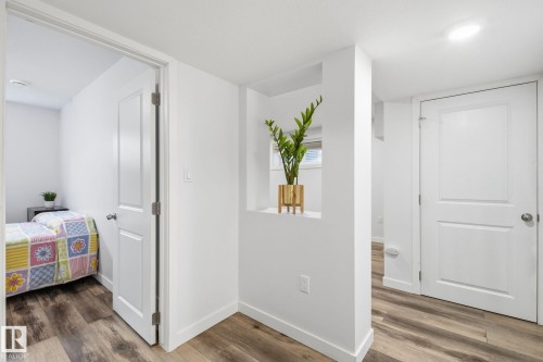 Wood-finish flooring throughout, bright white walls, recessed ceiling lighting, and white interior doors - 3016 24 Ave Nw, Edmonton, AB - Indoor