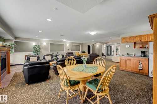 #209 237 Youville Dr E Nw, Edmonton, AB - Indoor Photo Showing Dining Room With Fireplace