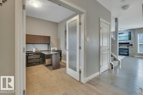 155 Kirpatrick Crescent, Leduc, AB - Indoor Photo Showing Other Room With Fireplace