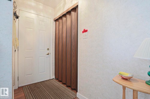 White paneled entry door with brass-finish hardware - 5203 45 Street, Beaumont, AB - Indoor Photo Showing Other Room