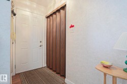 White paneled entry door with brass-finish hardware - 