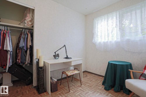 Parquet wood-finish flooring with a neutral wall palette - 5203 45 Street, Beaumont, AB - Indoor