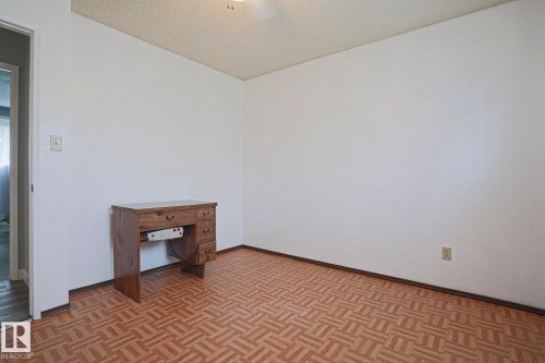 Room featuring white walls, patterned tile flooring, and a textured ceiling - 5203 45 Street, Beaumont, AB - Indoor Photo Showing Other Room