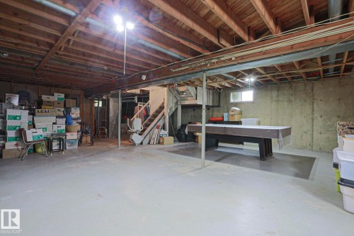Spacious unfinished basement offering exposed wood joists and concrete walls - 5203 45 Street, Beaumont, AB - Indoor Photo Showing Basement
