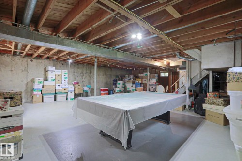 Spacious unfinished basement offering concrete flooring, exposed wood joists, a substantial support beam, and a staircase - 5203 45 Street, Beaumont, AB - Indoor Photo Showing Basement