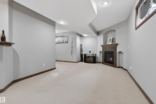 1213 Cunningham Drive Sw, Edmonton, AB - Indoor Photo Showing Other Room With Fireplace