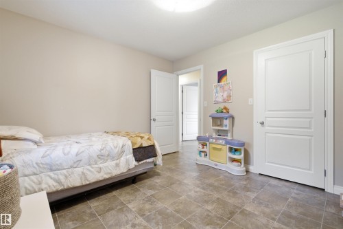 Spacious room featuring neutral wall tones, a flush-mount ceiling light, and white panel doors - 59125 Range Road 102, Rural St. Paul County, AB - Indoor Photo Showing Bedroom