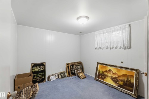 Recessed window, ceiling-mounted light fixture, light blue carpeting - 8031 135A Avenue Nw, Edmonton, AB - Indoor Photo Showing Other Room With Fireplace