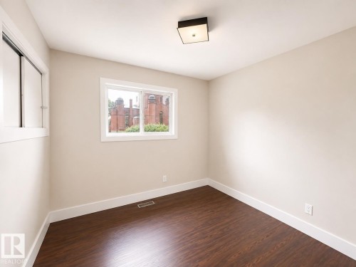 Wood-finish flooring, white trim, recessed lighting, and dual windows - 11934 64 Street Nw, Edmonton, AB - Indoor Photo Showing Other Room