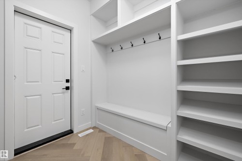 Built-in shelving unit with an integrated bench, coat hooks, and durable wood-finish flooring - 971 Elderberry Landing Nw, Edmonton, AB - Indoor