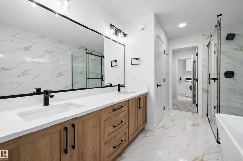 Dual vanity with wood-finish cabinetry and white countertops - 971 Elderberry Landing Nw, Edmonton, AB - Indoor Photo Showing Bathroom