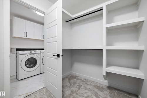 Built-in closet shelving and hanging rod - 971 Elderberry Landing Nw, Edmonton, AB - Indoor Photo Showing Laundry Room