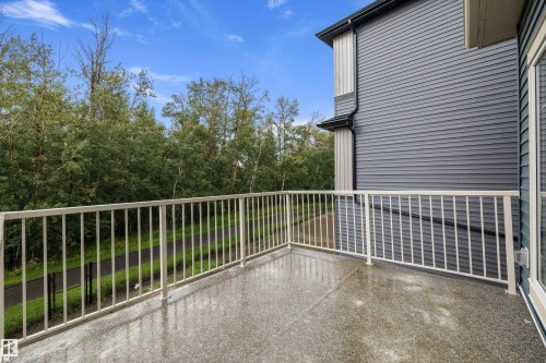 Private balcony with a textured surface, white metal railing, and a durable siding exterior - 971 Elderberry Landing Nw, Edmonton, AB - Outdoor With Exterior