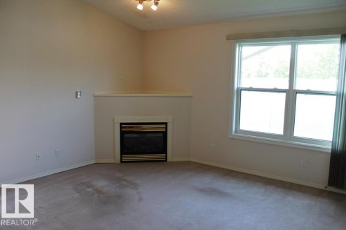 Tofield, AB - Indoor Photo Showing Other Room With Fireplace