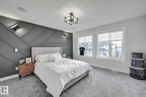 Accent wall with geometric paneling and integrated wall sconces - 265 Edgemont Green Nw, Edmonton, AB - Indoor Photo Showing Bedroom