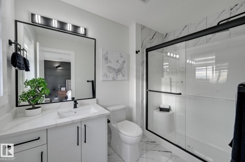 White vanity with a rectangular undermount sink and matte black faucet - 265 Edgemont Green Nw, Edmonton, AB - Indoor Photo Showing Bathroom