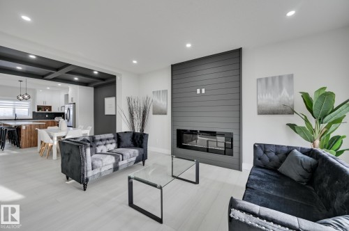 Modern electric fireplace with a shiplap feature wall - 265 Edgemont Green Nw, Edmonton, AB - Indoor Photo Showing Living Room With Fireplace