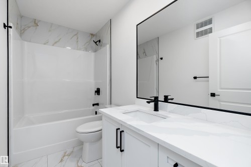 White vanity with an integrated sink, matte black faucet, and matching hardware - 1763 Crossbill Loop Nw, Edmonton, AB - Indoor Photo Showing Bathroom