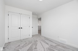 White walls with a light-colored carpet featuring a subtle pattern - 