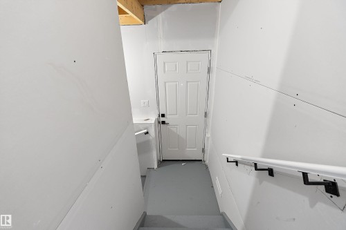 Finished white door with black hardware - 1763 Crossbill Loop Nw, Edmonton, AB - Indoor Photo Showing Other Room