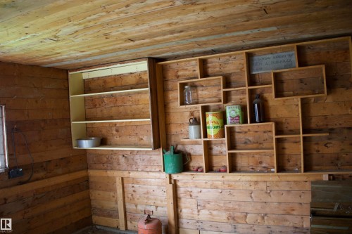 Wood-paneled walls and ceiling with a built-in shelving system - 4946 47 Street, Barrhead, AB - Indoor Photo Showing Other Room
