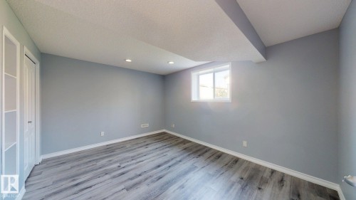 Wood-finish flooring, recessed lighting, and a white-framed window - 7848 7 Avenue Sw, Edmonton, AB - Indoor Photo Showing Other Room