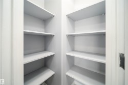 Built-in shelving with multiple levels, white finish, and corner configuration - 