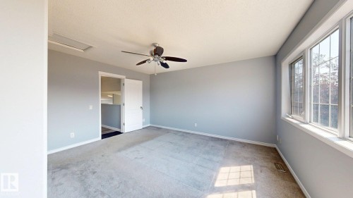 Recessed ceiling access panel, ceiling fan, white paneled door, and multi-pane windows - 7848 7 Avenue Sw, Edmonton, AB - Indoor Photo Showing Other Room