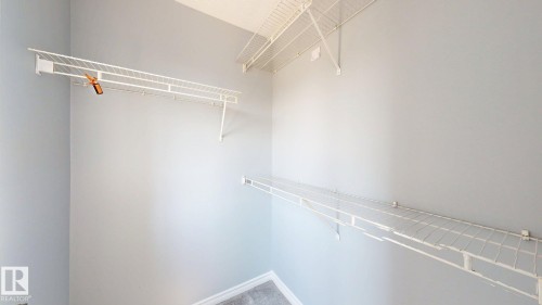 White wire shelving system - 7848 7 Avenue Sw, Edmonton, AB - Indoor With Storage