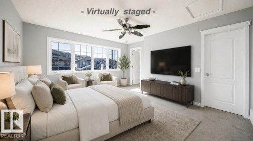 Multiple large windows, a ceiling fan with integrated lighting, solid core interior doors, and neutral wall tones - 7848 7 Avenue Sw, Edmonton, AB 