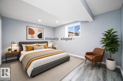 Recessed ceiling lighting, light blue wall paint, wood-finish flooring, white window trim, and white ceiling - 