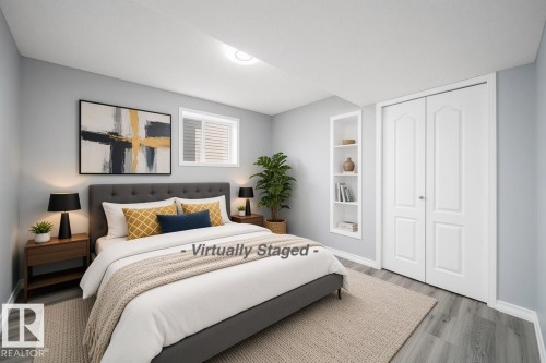 Wood-finish flooring, built-in shelving, and bi-fold closet doors - 7848 7 Avenue Sw, Edmonton, AB 
