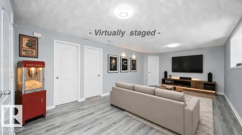 Wood-finish flooring throughout, light-colored walls, recessed ceiling lighting, and a white-trimmed window - 7848 7 Avenue Sw, Edmonton, AB 