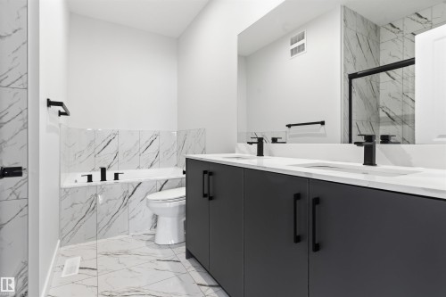 Dual vanity with undermount sinks and matte black fixtures - 8815 181 Avenue Nw, Edmonton, AB - Indoor Photo Showing Bathroom