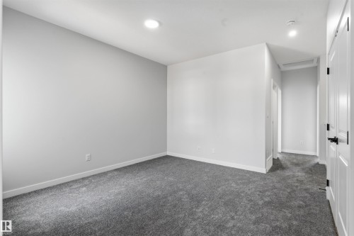 Recessed lighting, gray carpeting, neutral wall paint, and white trim - 8815 181 Avenue Nw, Edmonton, AB - Indoor Photo Showing Other Room