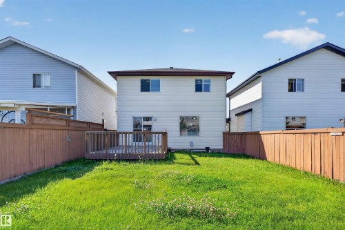 Expansive backyard featuring a manicured lawn, a privacy fence, and a wooden deck - 1816 36 Avenue Nw, Edmonton, AB - Outdoor With Deck Patio Veranda With Exterior