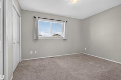 Neutral wall color, carpet flooring, window with blinds, bi-fold closet doors, and ceiling-mounted light fixture - 