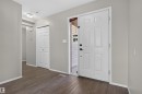 Entryway featuring a white paneled door, wood-finish flooring, light grey walls, white trim, and a flush mount ceiling light - 1816 36 Avenue Nw, Edmonton, AB  - Indoor Photo Showing Other Room 