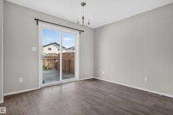 Sliding glass door access to an outdoor patio with wood privacy fencing - 