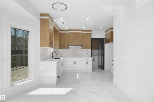 Kitchen featuring wood-finish upper cabinetry, white lower cabinetry, and a large window - 6823 18 Avenue Sw, Edmonton, AB - Indoor Photo Showing Kitchen