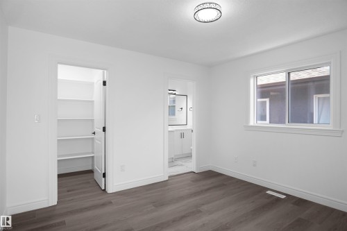 Wood-finish flooring with white walls and trim - 6823 18 Avenue Sw, Edmonton, AB - Indoor Photo Showing Other Room