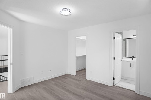 Bright interior with wood-finish flooring - 6823 18 Avenue Sw, Edmonton, AB - Indoor Photo Showing Other Room