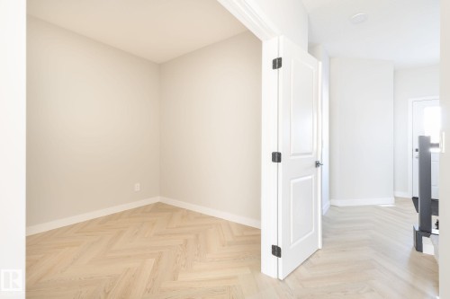 Wood-finish flooring with a herringbone pattern - 24 Clichy Close, St. Albert, AB - Indoor Photo Showing Other Room