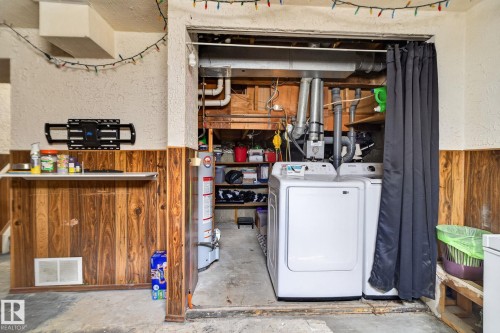Laundry area with a water heater and visible utility connections - 8031 27 Avenue Nw, Edmonton, AB - Indoor Photo Showing Laundry Room